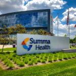 Glass walled hospital with Summa Health sign out front