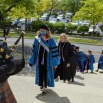 A bagpiper leads CWRU nursing faculty and students during graduation procession