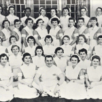 Class photo of nurses in white from 1956